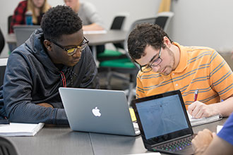 Two students reviewing answers